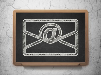 email icon on Black chalkboard on grunge wall background